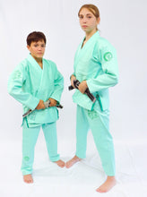 Load image into Gallery viewer, Two individuals wearing mint green martial arts uniforms on a white background
